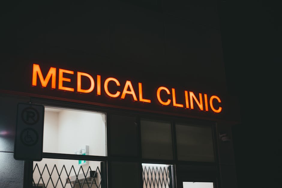 Bright neon medical clinic signage at night, creating a vivid street scene.